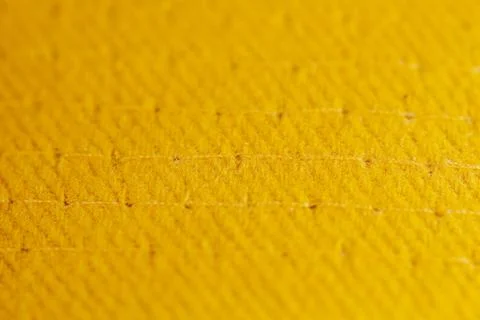 Part of a yellow baseball cap with a small depth of field Stock Photos