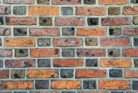 Parti-colored brick wall Stock Photos