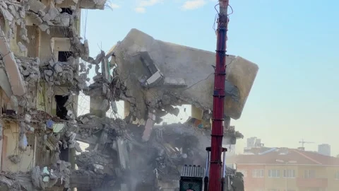 Partial building collapse during hydraulic crusher demolition in Bagcilar Stock Footage 334011818