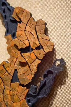 Partial close-up of orange leaf collage necklace exhibit Stock Photos