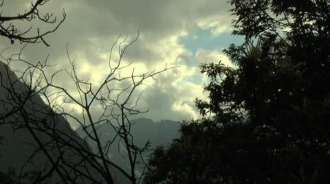 Partial Cloud Cover with Mountains and Tree Branches 動画素材 32255808