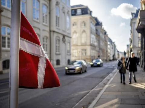 Partial Danish Flag as it flutters on the sidewalk along Bredgade Stock Photos