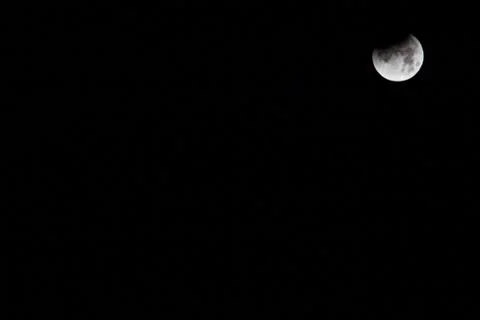 Partial Eclipse of moon, located top right of photo Stock Photos
