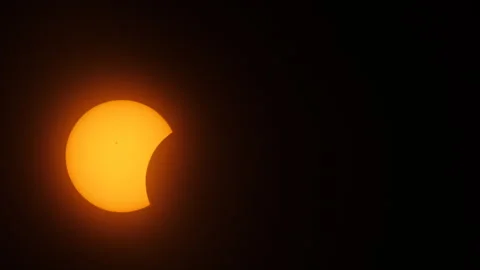 Partial eclipse phase of the April 8th, 2024 Total Solar Eclipse in Stock Footage 273272562