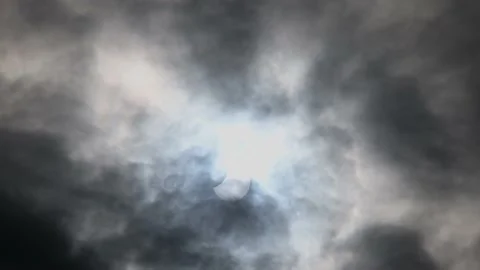 Partial eclipse of the Sun. Annular eclipse viewed through clouds Stock Footage 219885795