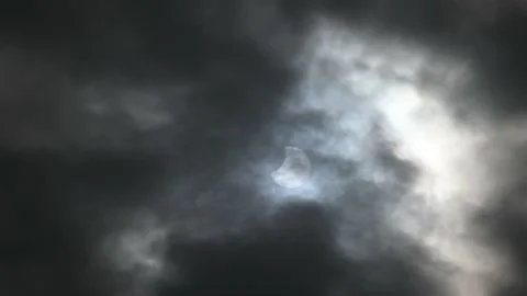 Partial eclipse of the Sun. Annular eclipse viewed through clouds. Stock Footage 219885796