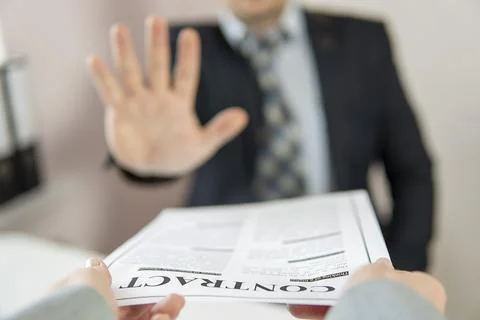Partial focus. businessman refuses a contract that is handed to him. high qua Stock Photos
