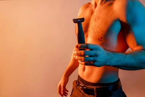 Partial image of man with electric shaver in hand Stock Photos