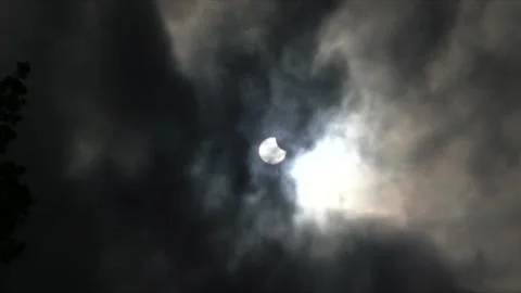 Partial lunar eclipse with clouds passing by Stock Footage 286362771