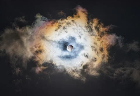 Partial Lunar Eclipse Over a Multicolored Cloudy Sky Stock Photos