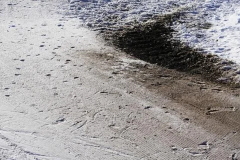 Partial melting of snow, a patch, spot or puddle of sand or ground from under Stock Photos