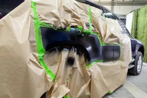 Partial painting of the side elements of the body of a black SUV car after an Foto stock