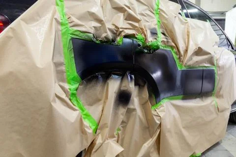 Partial painting of the side elements of the body of a black SUV car after an Foto stock
