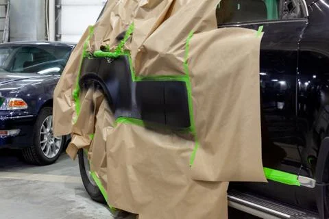 Partial painting of the side elements of the body of a black SUV car after an Foto stock