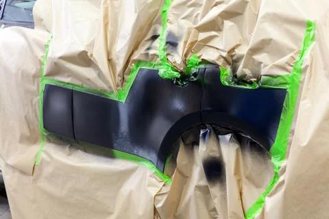 Partial painting of the side elements of the body of a black SUV car after an Foto stock