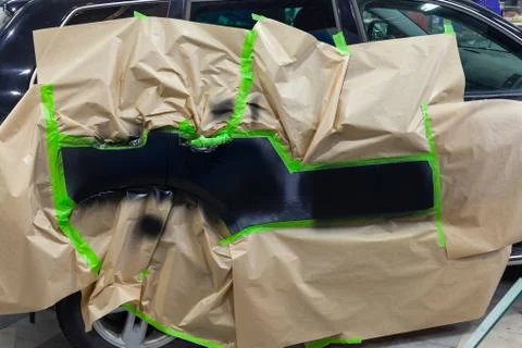 Partial painting of the side elements of the body of a black SUV car after an Stock Photos