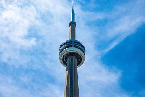 Partial shot of the CN Tower under blue cloudy sky Stock Photos