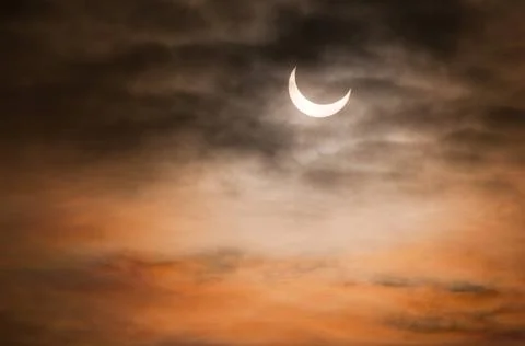 Partial solar eclipse and clouds morning sky Partial solar eclipse and clo... Stock Photos