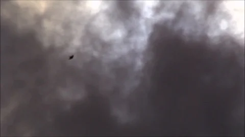 Partial solar eclipse and passing dark rain clouds Stock Footage 121905606