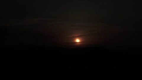 Partial Solar Eclipse Behind Dark Clouds Stock Footage 344440734
