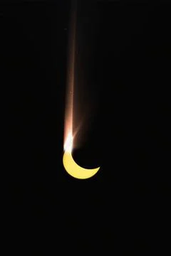 Partial solar eclipse on black background. Moon shadow covered part of sun Fotos Stock