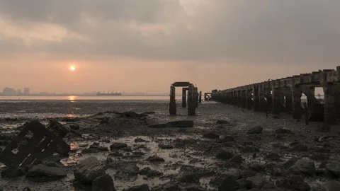 Partial solar eclipse at the broken bridge pillar Stock Footage 86245666