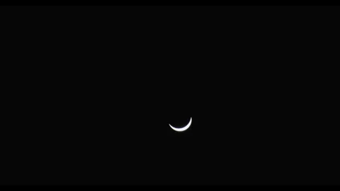 Partial solar eclipse captured at night with the crescent shape glowing in Stock Footage 277182139