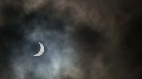 Partial solar eclipse with clouds Stock Footage 49825558