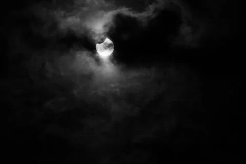 Partial solar eclipse with cloudy sky Fotos Stock