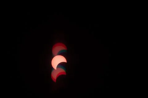 Partial solar eclipse with colorful flares in the sky Fotos Stock