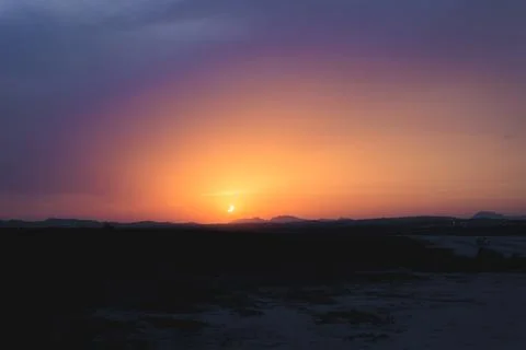 Partial solar eclipse creating a crescent sun appearing on the horizon duri.. Stock Photos