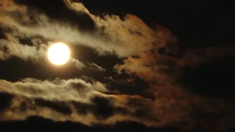 Partial solar eclipse glows in a dark sky as the Moon obscures part of the Sun Stock Footage 344020037