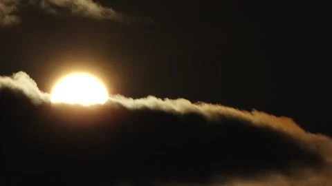 Partial solar eclipse glows in a dark sky as the Moon obscures part of the Sun Stock Footage 344020145