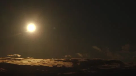 Partial solar eclipse glows in a dark sky as the Moon obscures part of the Sun Stock Footage 344020385