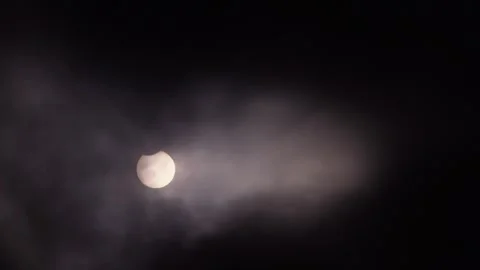 Partial Solar Eclipse of June 10 2021 Visible Through Clouds Stock Footage 340968214