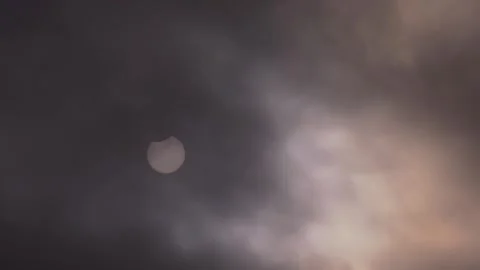 Partial Solar Eclipse of June 10 2021 Visible Through Clouds Stock Footage 340968276
