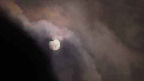 Partial Solar Eclipse of June 10 2021 Visible Through Clouds Stock Footage 340968281