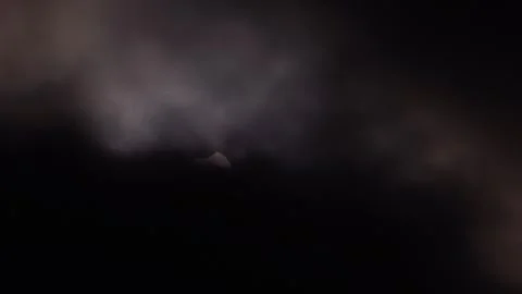 Partial Solar Eclipse of June 10 2021 Visible Through Clouds Stock Footage 340968289