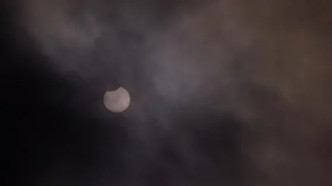 Partial Solar Eclipse of June 10 2021 Visible Through Clouds Stock Footage 340968313