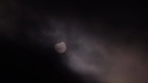 Partial Solar Eclipse of June 10 2021 Visible Through Clouds Stock Footage 340968315