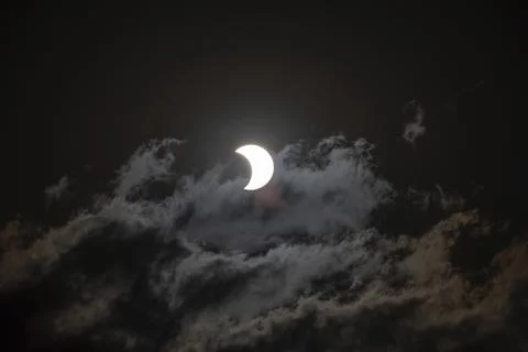 Partial solar eclipse with light cloud cover on 2 October 2024 in Buenos Aires, Stock Photos