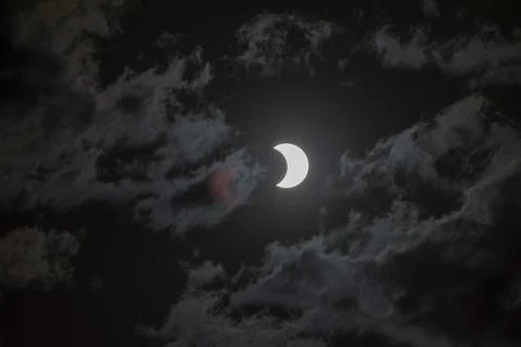 Partial solar eclipse with light cloud cover on 2 October 2024 in Buenos Aires, Stock Photos