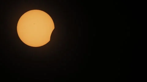 Partial solar eclipse with moon covering sun. Video stock 332034039