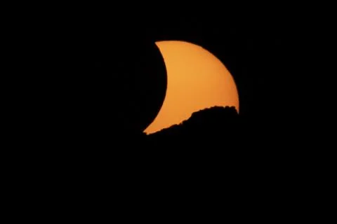 Partial Solar Eclipse with the Moon Crossing the Sun Stock Photos