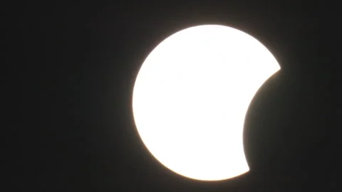 Partial Solar Eclipse as Moon Starts to Dim Sunlight. 스톡 동영상 345917716