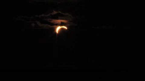 Partial Solar Eclipse Over Riga Latvia - Dramatic Crescent Sun In Clouds Stock Footage 345473819
