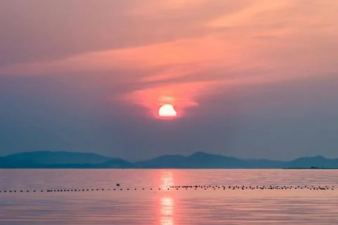 Partial solar eclipse partial solar eclipse on lake in sunset Copyright: x... Fotos Stock