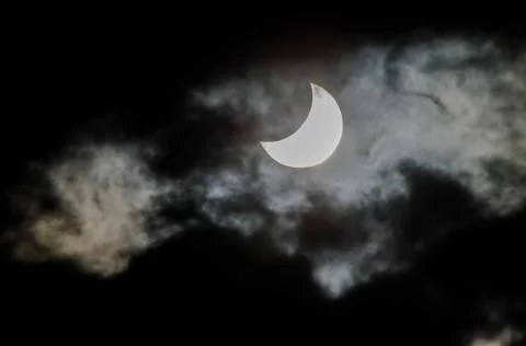 Partial Solar Eclipse Partial Solar Eclipse on a Cloudy Day Copyright: xZo... Fotos Stock