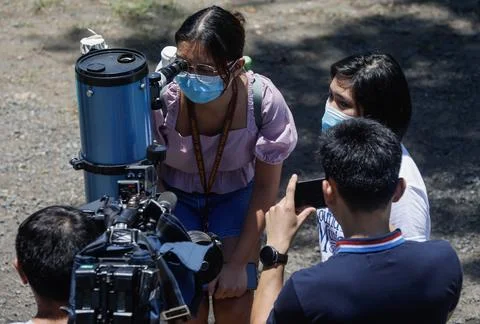 Partial solar eclipse seen from Metro Manila, Quezon City, Philippines - 20 Apr  Fotos Stock