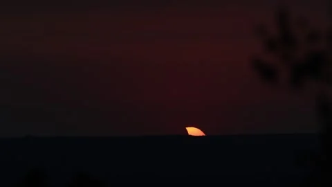 Partial solar eclipse setting over the horizon in Lleida, Spain Stock Footage 344136100